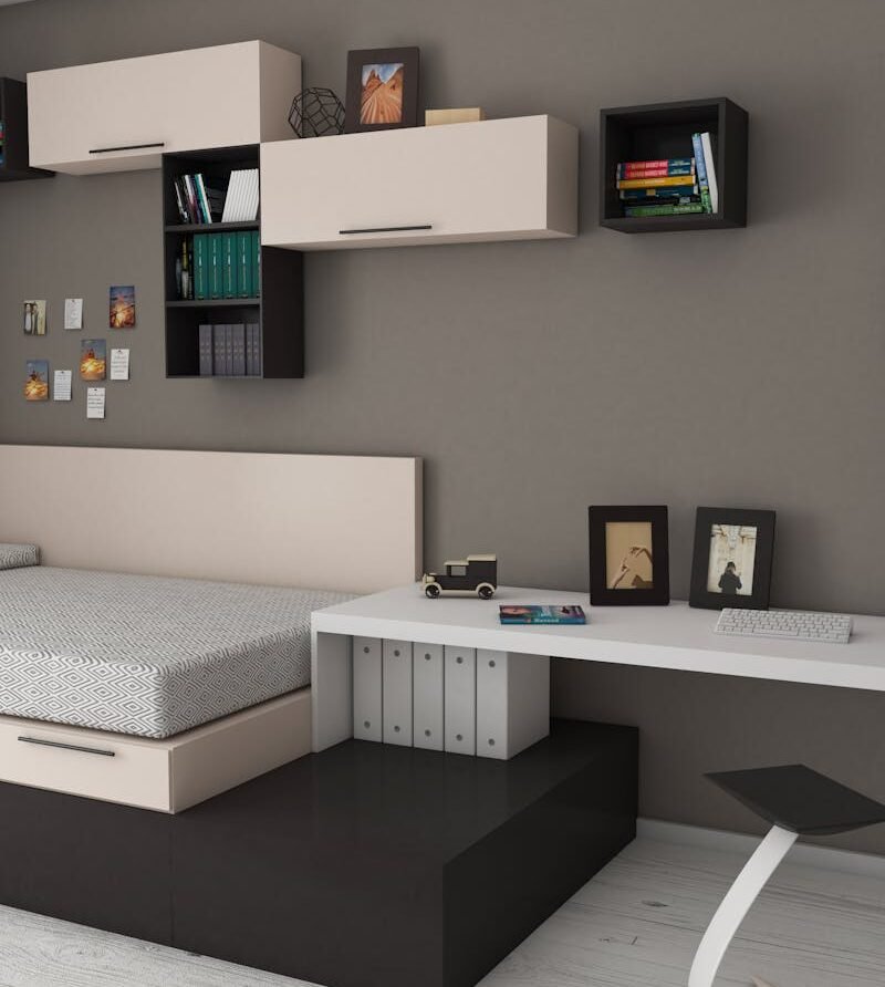 Stylish minimalist bedroom with modern furnishings and workspace area, perfect for home offices.
