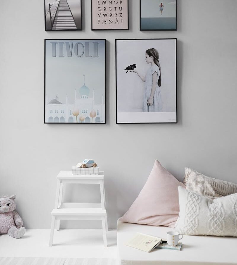 Minimalist Scandinavian bedroom with wall art and cozy decor elements.