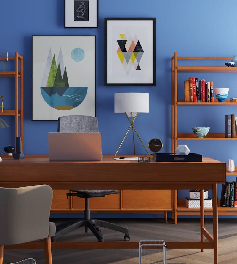 Elegantly decorated home office with modern furniture and a blue wall.